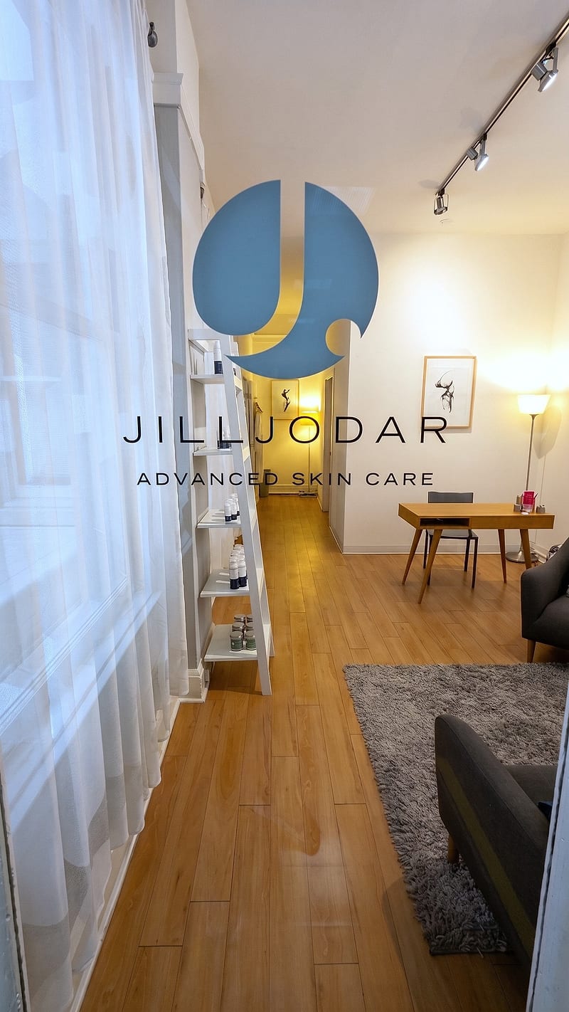 The sunlit entry at Jill Jodar Advanced Skin Care -- product shelves along the window and a consultation desk beyond
